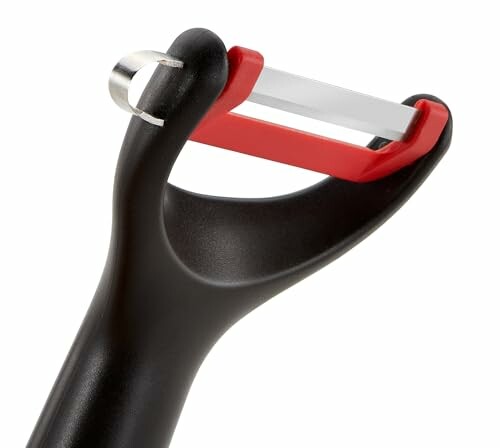 Éplucheur de légumes en céramique avec manche noir.